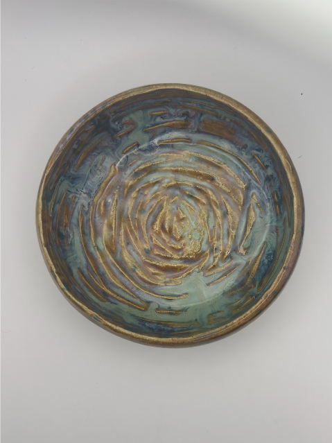 A Small Handcrafted Ceramic Bowl with Mesmerizing Swirl Glaze
