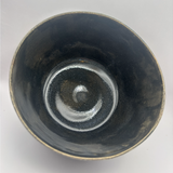 Top view inside handmade dark serving bowl showing glossy variegated interior
