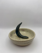 Clean view of handmade ceramic jewelry dish with sculptural crescent moon ring holder on white background